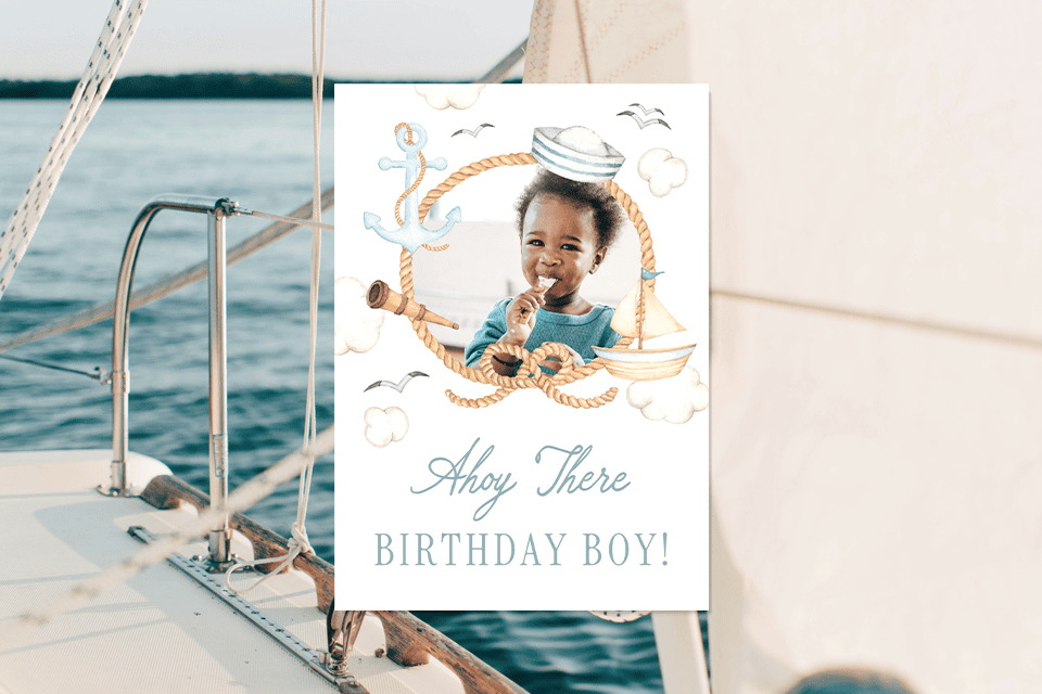 ahoy-there-birthday-boy-son-birthday-card (1) Nautical birthday card featuring a smiling baby boy inside a rope life ring with sailor hat, anchor, sailboat, and seagull illustrations, set against a sailboat background, with the text “Ahoy There Birthday Boy!”.