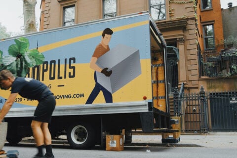 A moving truck and stacked boxes, symbolizing the process of moving and changing residences. This image represents the logistics and effort involved in relocating to a new house.
