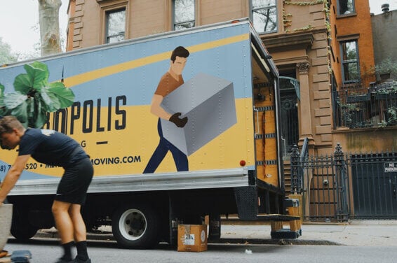 A moving truck and stacked boxes, symbolizing the process of moving and changing residences. This image represents the logistics and effort involved in relocating to a new house.
