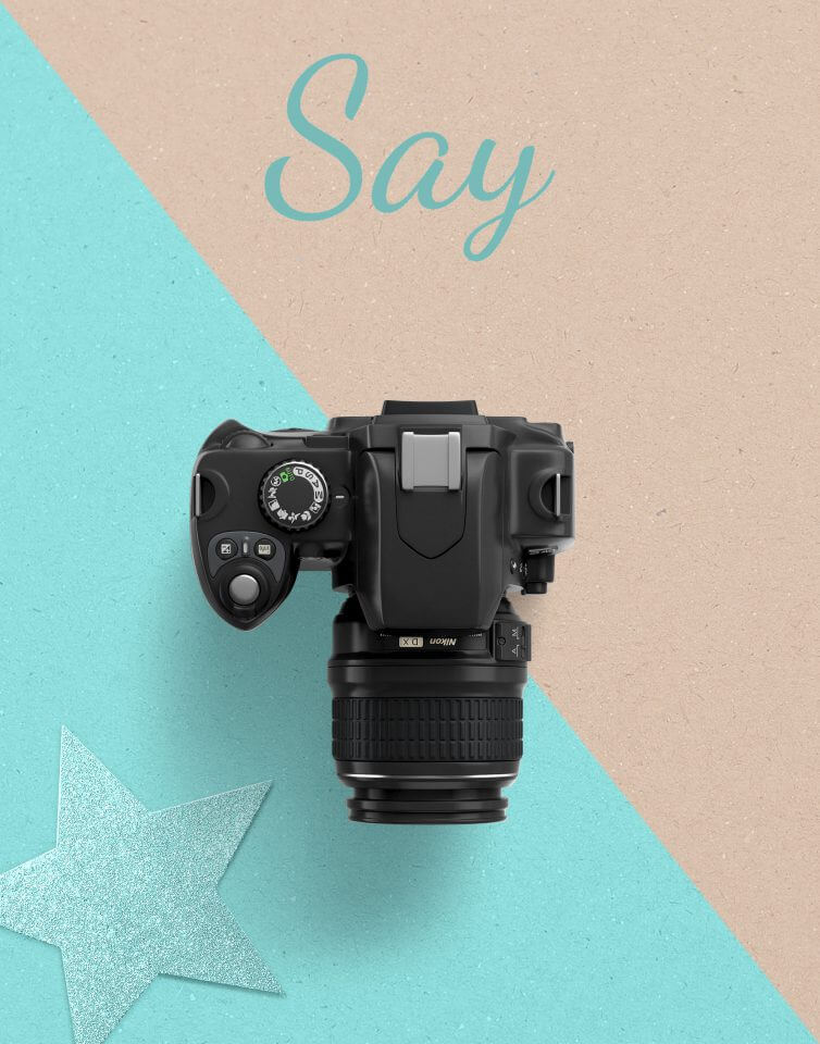 digital camera, placed on surface with blue sparkly star and word say