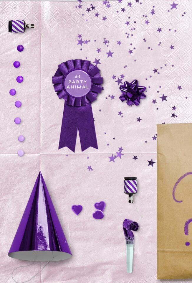 Purple-themed Party Favors: Paper Bag filled with Fun Surprises, adorned with a Stylish Purple Birthday Hat and Badge
