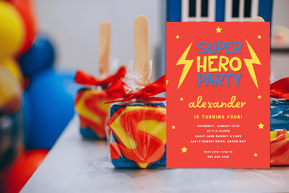 super-hero-bithday-invite (1) Superhero-themed birthday party invitation standing beside colorful wrapped party favors with red ribbons, featuring bold red, yellow, and blue colors and playful lightning bolt graphics for a child’s birthday celebration.