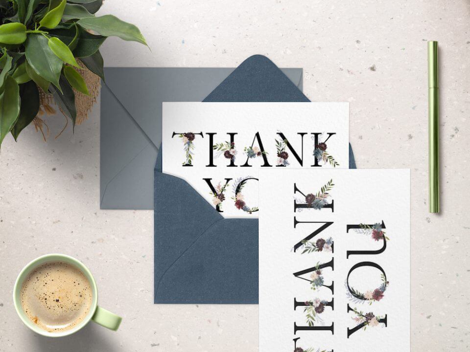 thank you cards template placed on top of open envelope with cup of coffee and flowers