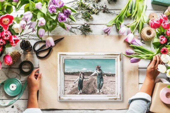 A framed photograph surrounded by a bouquet of flowers, possibly representing one of the 'Mother's Day Activity and Gift Ideas'.