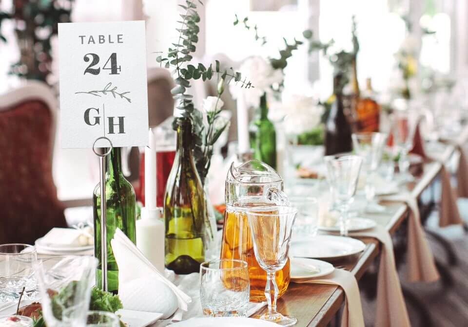 Perfect Wedding Invitations Design: Crafting a Personalised Wedding Monogram. Elegant Table Setting with Table Number Featuring Monogram, Drinks, and Dinner Plates.