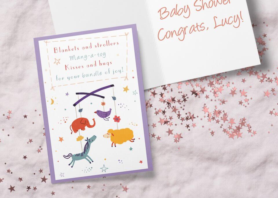 Sweet 'Bundle of Joy' New Baby Card showcasing an illustration of a crib mobile with endearing figures: elephant, bird, horse, and sheep.