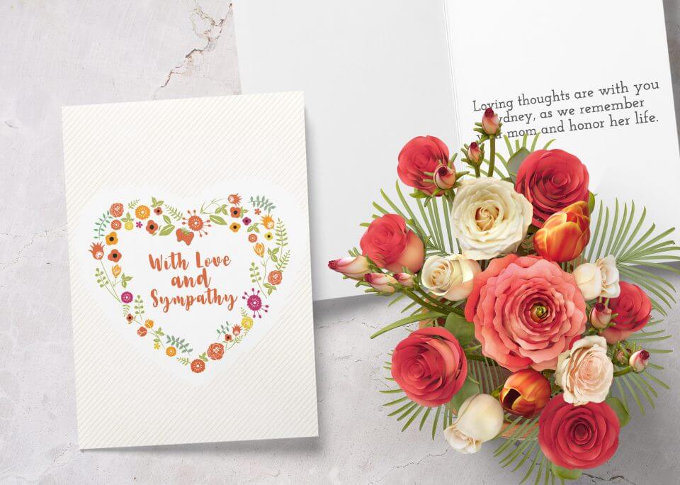 With Love and Sympathy Card: Adorned with a Heart-Shaped Flower Wreath – Positioned Near a Bouquet of Flowers and an Open Note, Offering Love and Support during Difficult Times.