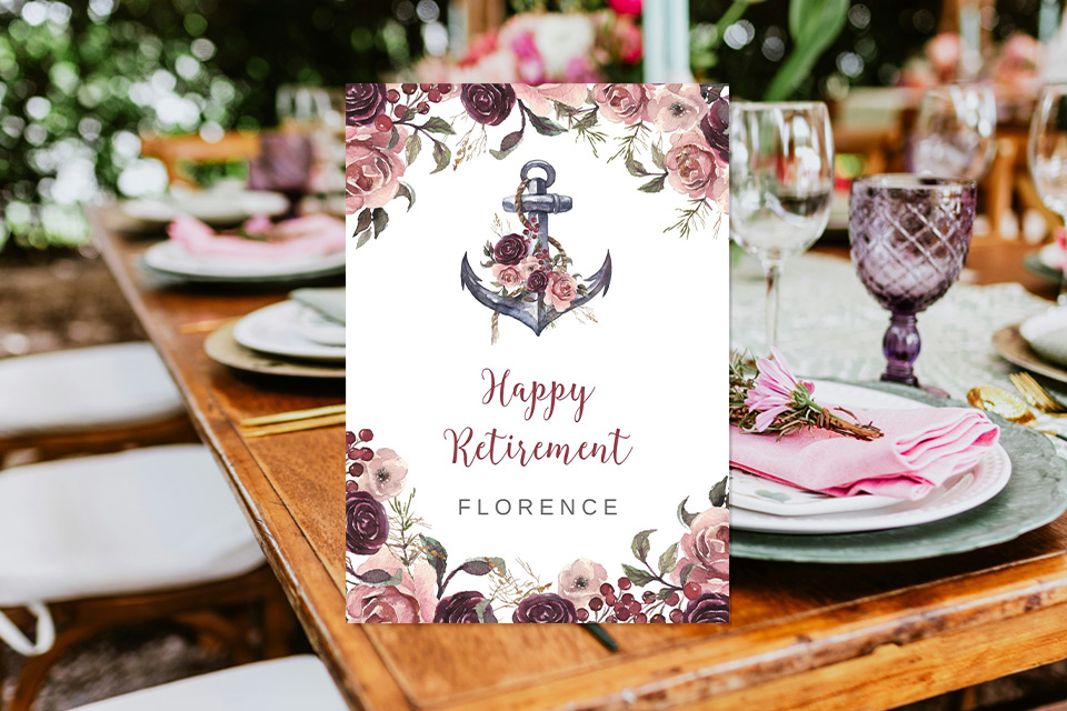 happy-retirement-floral-card-elegant-dinner Elegant floral retirement card displayed on decorated dinner table with champagne glasses and romantic celebration setting.