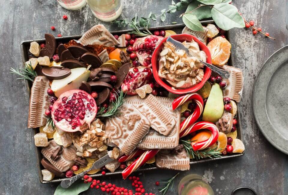 Delightful Christmas Appetizers: Festive Charcuterie Board Featuring Candy Canes, Assorted Spreads, Artisan Crackers, Juicy Pomegranate Seeds, Delectable Cookies, Fresh Fruits, and Chocolate Treats, All Decked Out for Your Merry and Bright Christmas Party! (Cover for Blog Post: '20 Christmas Party Theme Ideas to Make Your Holiday Merry and Bright')