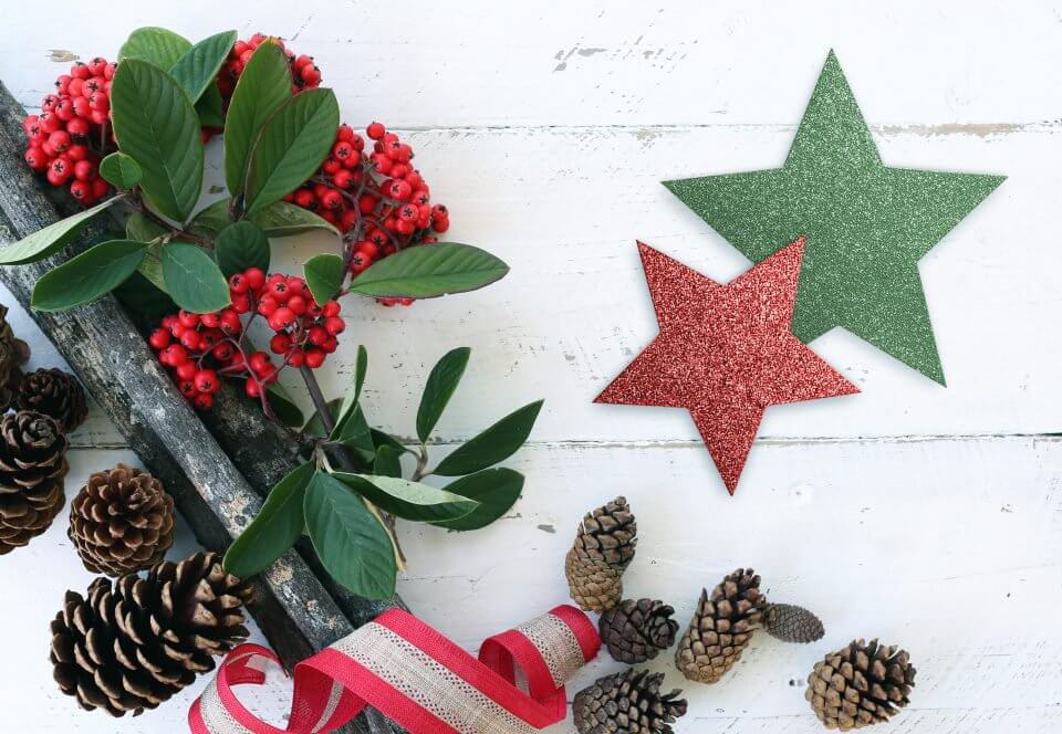 Enchanting Christmas Decorations: Glittering Green and Red Star Ornaments, Vibrant American Holly Branch, Assorted Pine Cones for a Rustic Holiday Charm