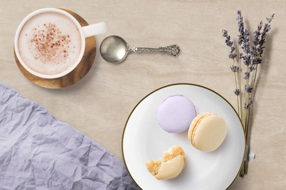 Ways to Express Love: Order Goodies From a Local Bakery – Savoring Purple and Yellow Macarons, a Cup of Coffee, and the Fragrance of Lavender Branches – A Sweet Gesture to Show Your Affection.