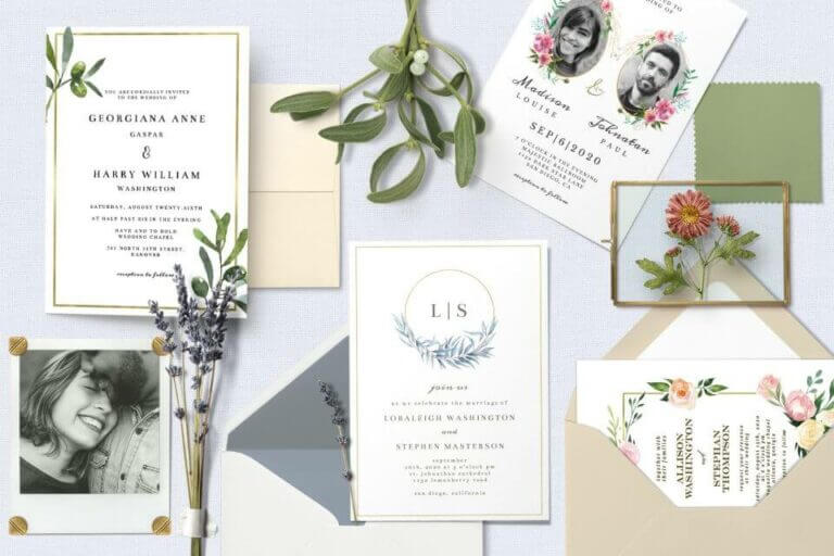 Elegant wedding invites, envelopes, photo, and flowers in a flat lay arrangement. Diverse colors and shapes create visual interest. Cover for 'Wedding Words: Invitation Wording Made Simple' blog post.