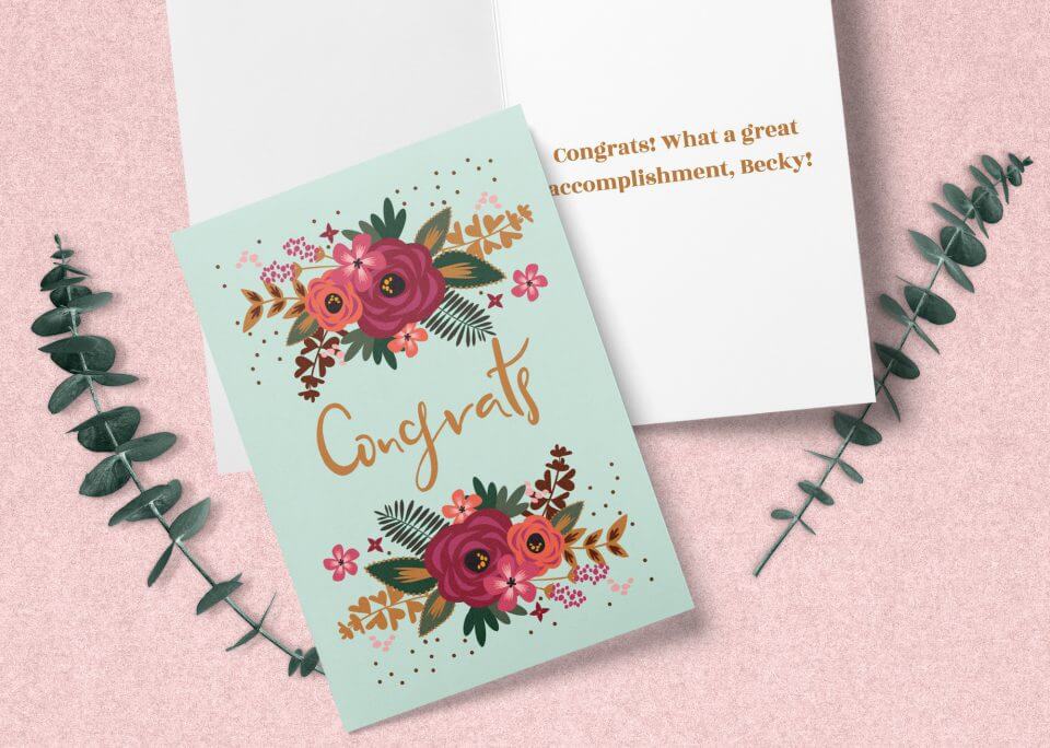 A Teal Background Bursting with Colorful Flower Illustrations, Highlighting the Word 'Congrats' in Light Brown – Resting Atop an Open Card with a Special Note Inside.