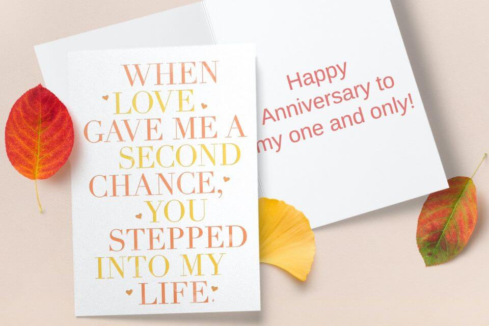 Celebrate the occasion with an anniversary card featuring warm yellow and orange text, accentuated by the beauty of autumn leaves nearby, creating a vibrant and seasonal expression of love and joy.