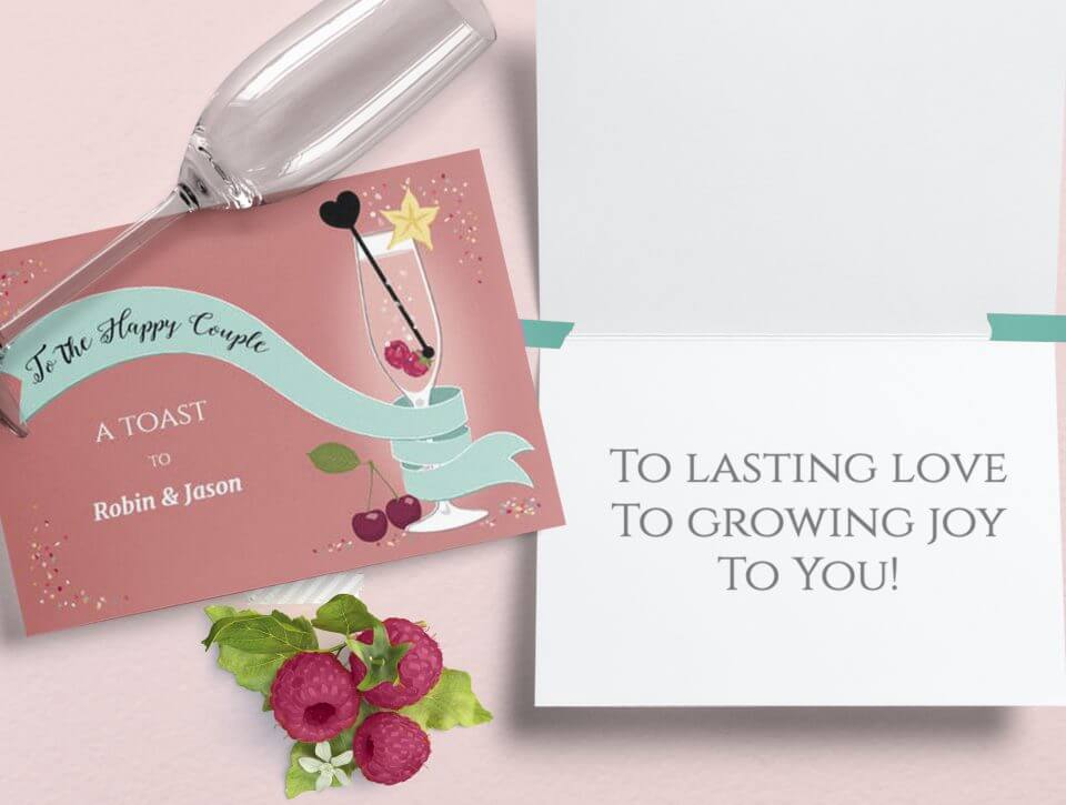 Champagne flute-themed wedding card: 'To the happy couple, a toast to...'. Open card with a quote. Champagne flute rests atop, garnished with three raspberries.