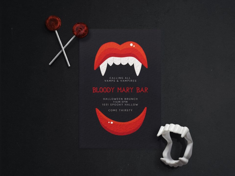 Halloween brunch party invitation featuring a striking black design with an open mouth, red lips, and menacing vampire fangs. The invitation reads 'Calling all vamps and vampires - Bloody Mary Bar' in bold red text. Placed on a black background with a pair of plastic fangs and two vibrant red lollipops.