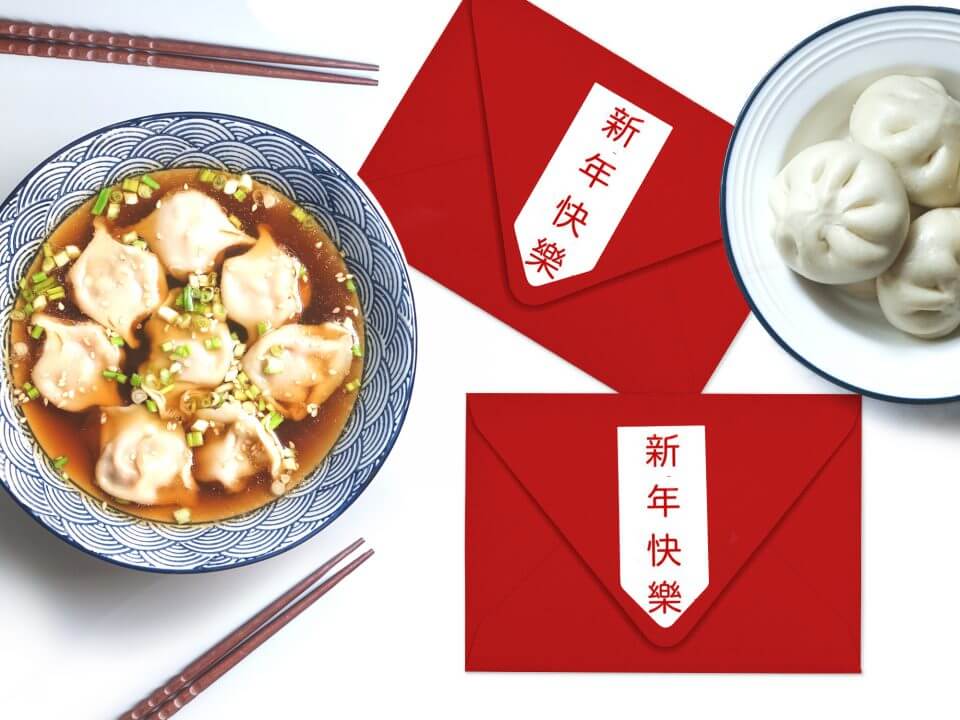 Embracing the global spirit of Chinese New Year, an international celebration marked by a delightful scene featuring a bowl of dumpling soup, accompanied by chopsticks, and adorned with traditional red envelopes.