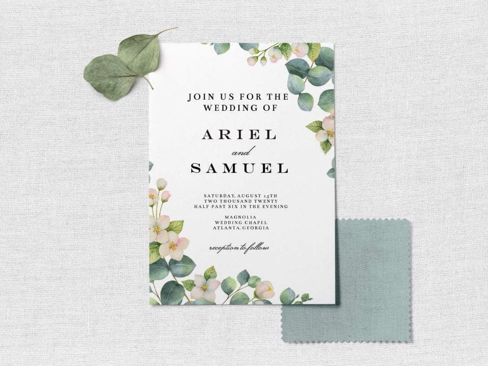 Botanical & White Flowers Wedding Invite: Illustrated flowers grace corners, with dark green text. Rests on light grey surface, accented by two small leaves.