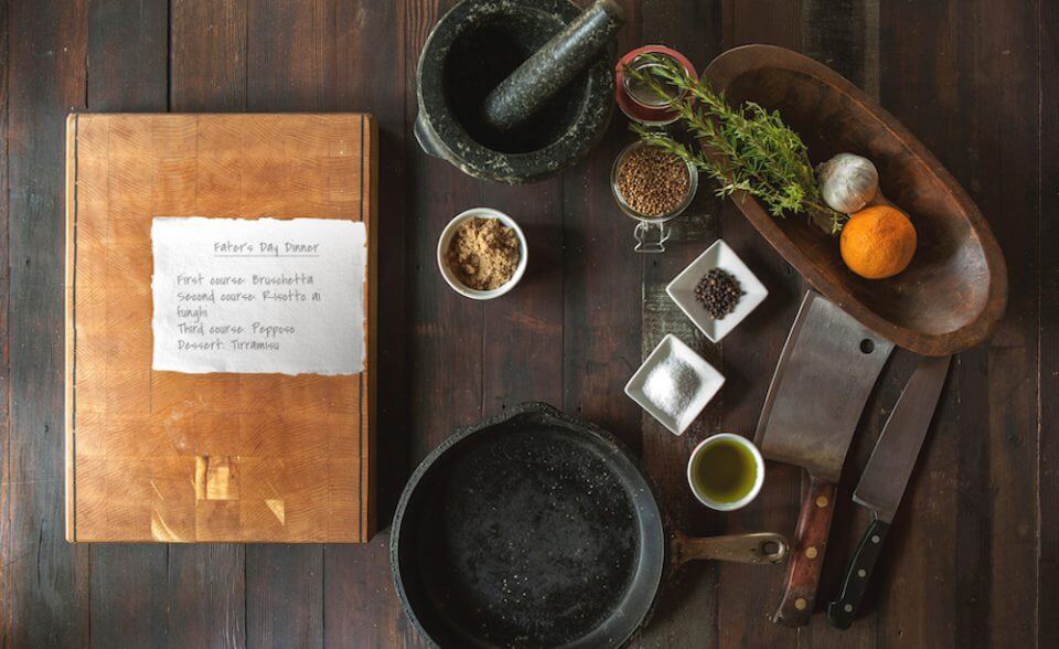 An image of a Culinary Subscription Box, featuring various dinner preparation items laid out. This image showcases the contents of the subscription box, which likely includes ingredients and tools for preparing a delicious meal