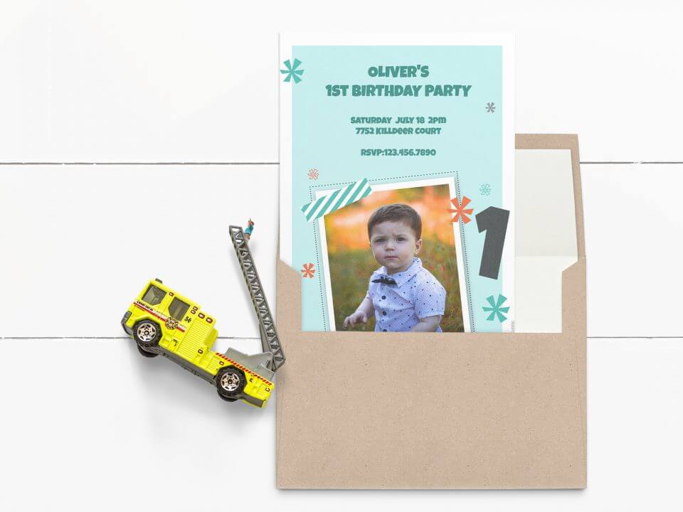 Sweet First Birthday Photo Invitation in Light Blue, Featuring a Baby's Picture Frame. Resting on an Open Envelope, Toy Firefighter Truck Nearby.