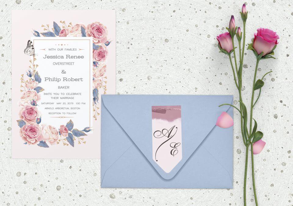 Monogram Wedding Invitations: Light Pink Background with Pink Flower and Butterfly Illustrations. White Text Area with Black Font on a Marble Surface Near Light Blue Envelope and Flowers.