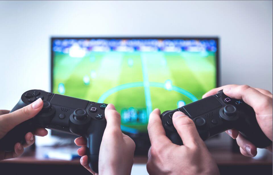 A gaming console featured in '20 Father’s Day Ideas to Make Dad Feel Special', with people actively engaged in gameplay using controllers. This image represents one of the creative ideas to celebrate Father's Day
