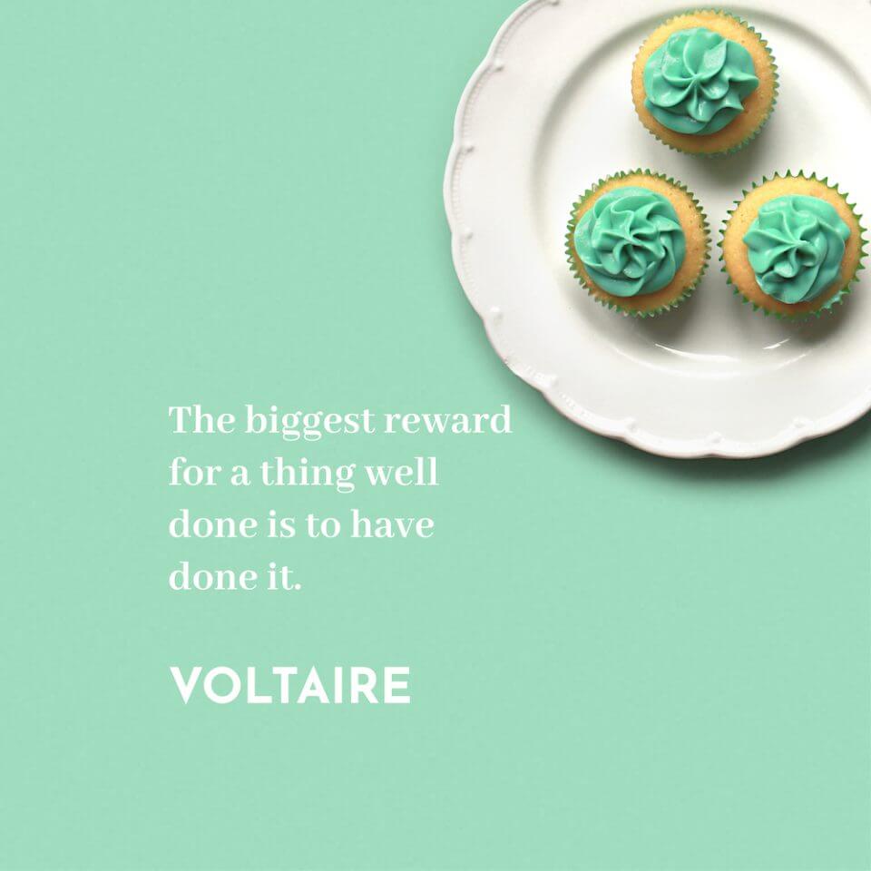 Voltaire Quote: 'The biggest reward for a thing well done is to have done it.' – Paired with a Background of a Plate Holding Three Cupcakes with Green Frosting