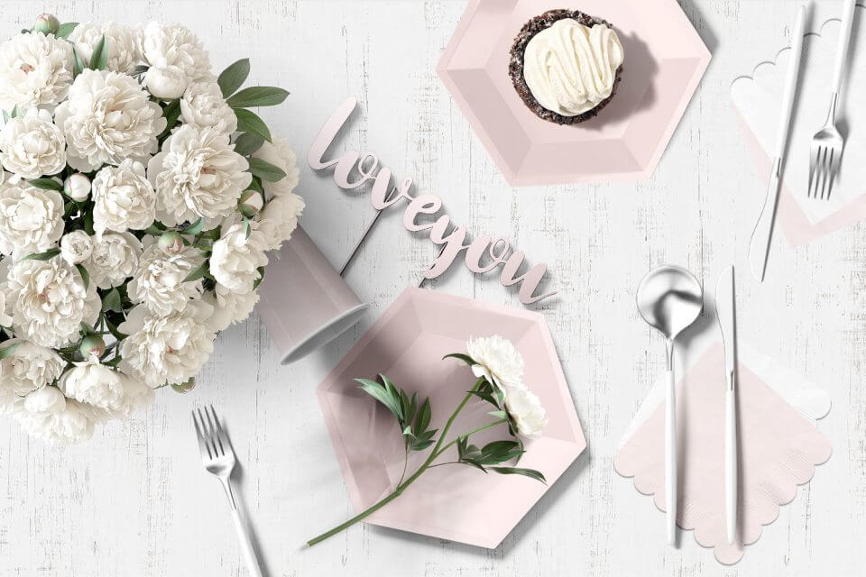 Romantic Wedding Anniversary Table Setting with White Flowers, Pink Plates, and Cupcake and words I Love You. Elegant and Serene Ambiance. Cover for '15 Wedding Anniversary Party Themes'