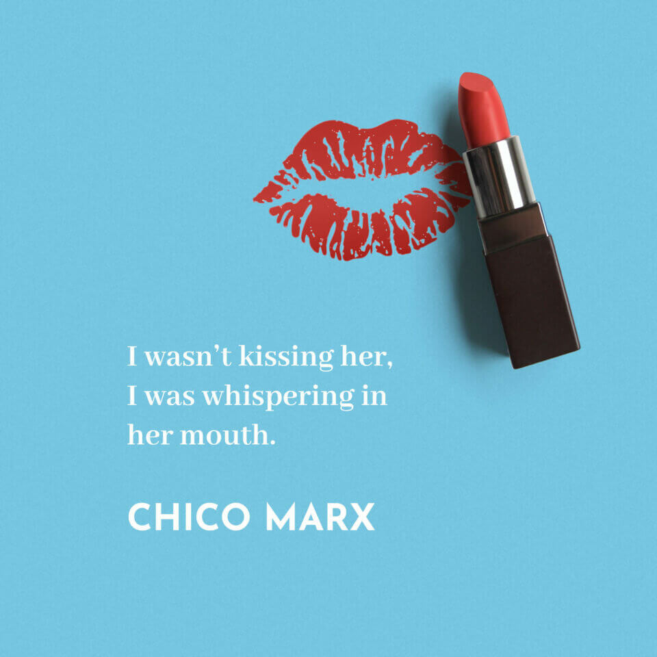 Quote by Chico Marx: 'I wasn’t kissing her, I was whispering in her mouth.' The text is presented in white against a backdrop with a blue lipstick stain and a lipstick.