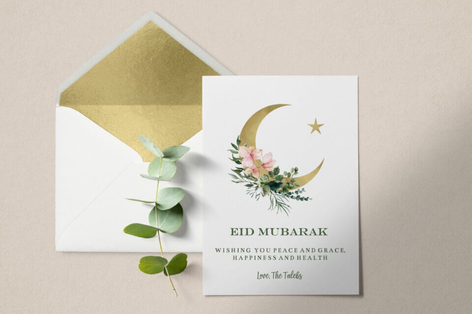 Eid Mubarak Golden Moon Card: A stunning design adorned with golden moon, floral elements, and delicate branches, offering a touch of elegance. Positioned near an open envelope, it creates a harmonious tableau, perfect for conveying heartfelt Ramadan messages.