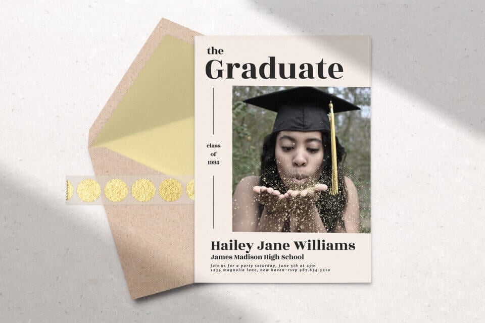 A Gold and Pink Graduation Announcement card and matching envelope, with the card prominently featuring a photograph of a woman proudly wearing a graduation cap. 