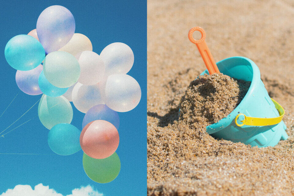 Colorful Balloons Dance in the Clear Blue Sky, while a Close-Up Reveals a Child's Blue Bucket Brimming with Sand on a Sun-Drenched Beach.