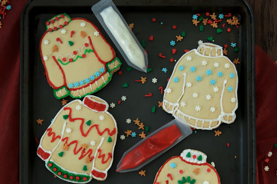 Adorable Christmas Sweater Cookies Arranged on a Festive Tray
