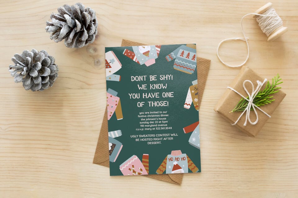 Invitation to Ugly Christmas Sweater Party: Dark green background with playful ugly sweater illustrations. Set on a light wood backdrop with a pine cone and small gift accent.