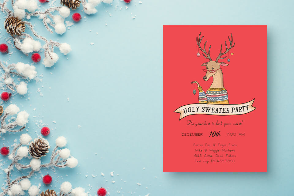 Top view of Christmas decorations: Snow-covered branches with red berries and pine cones on an isolated pastel blue background, accompanied by an invitation to an Ugly Sweater Christmas Party. The invitation is red with an illustration of a reindeer.