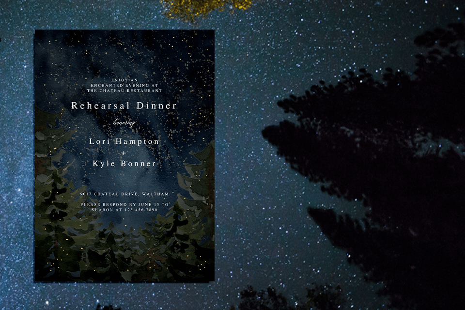 Wedding Rehearsal Dinner invitation graced with an enchanting illustration of a dark starry night, adorned with trees and golden dots resembling fireflies. The elegant white text complements the magical scene, set against a backdrop of an actual night sky teeming with stars.