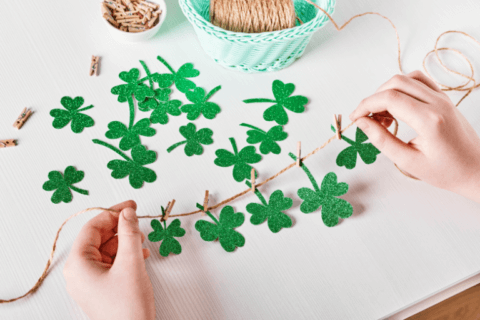 St. Patrick's Day Celebration: Hands crafting a leafy garland, adding a touch of green to the festivities.