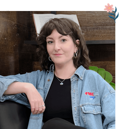 Portrait of Bethan Richards, radiating a warm smile, embellished with an illustrated flower in the upper right corner.