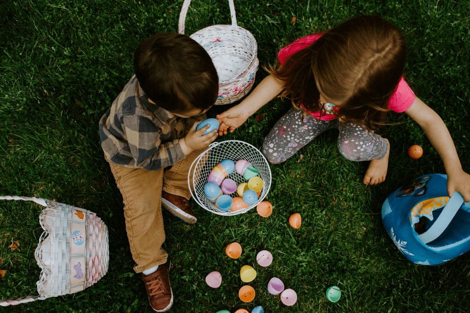 kids gathering plastic eggs for easter game egg hunt