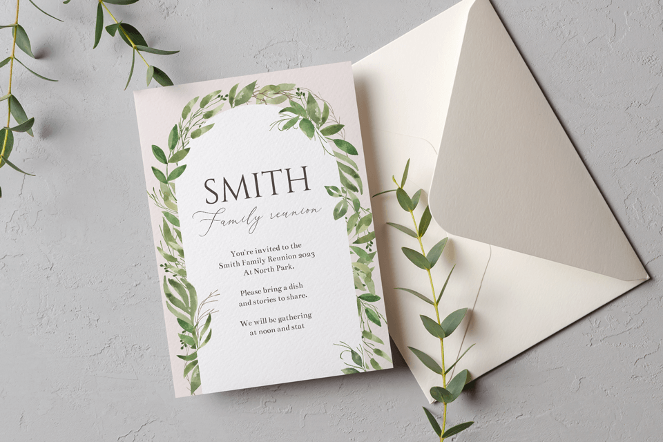 Family reunion invitation adorned with a garland of leaves, elegantly placed atop a coordinating envelope, ready for sending warm gatherings.