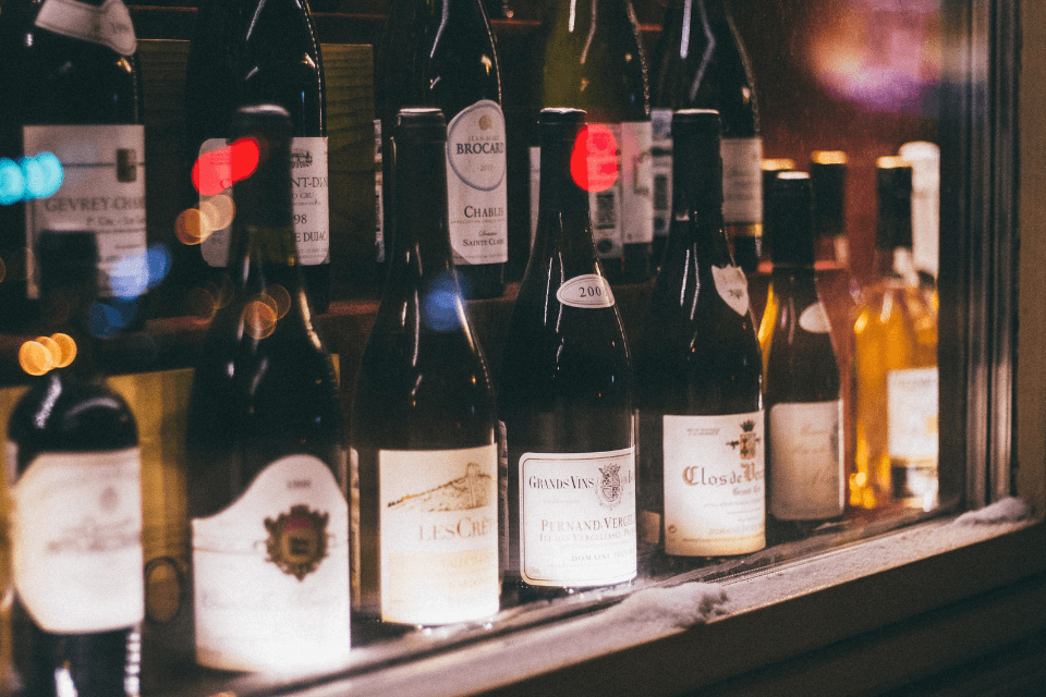 Wine bottles meticulously arranged on a display, showcasing a curated selection of vintages and vineyards.