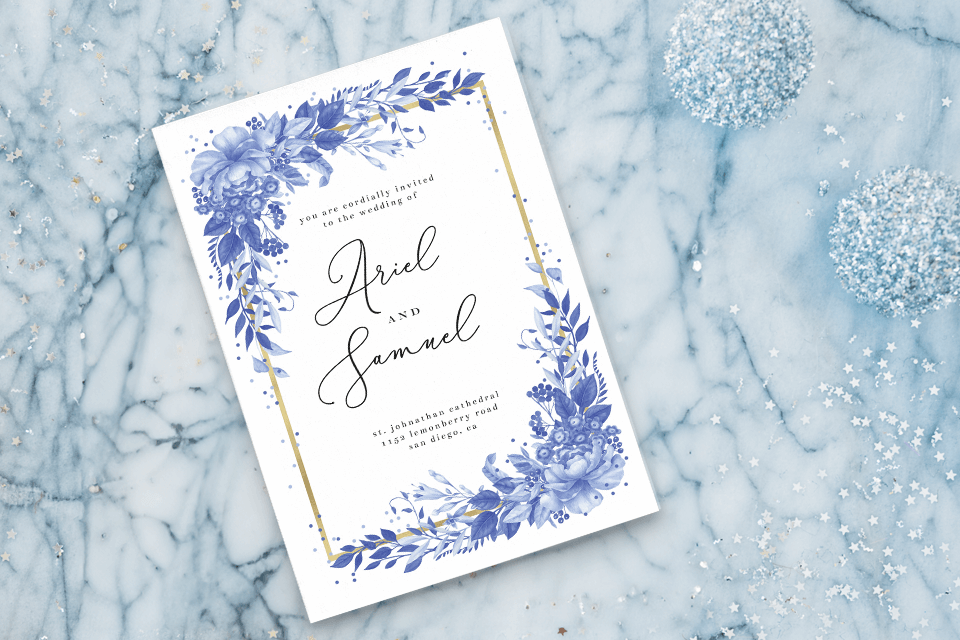 Elegant winter wedding invitation adorned with a delicate frozen floral border and tasteful gold accents. The invitation is artistically placed over a mesmerizing background that features a close-up view of intricate snowflakes, highlighting the enchanting and unique charm of a winter-themed wedding.
