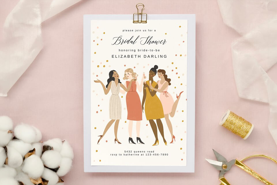 Bridal Shower Invitation: Illustrated women joyfully cheering with champagne glasses, exuding celebration and camaraderie. Set against a light pink surface adorned with golden thread and a pair of scissors, symbolizing the crafting of cherished memories.