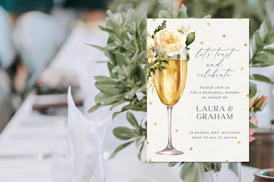 Elegant rehearsal dinner invitation adorned with an illustration of a champagne flute brimming with effervescence, crowned with a lush bouquet of flowers. Set against the backdrop of a beautifully decorated dinner table.