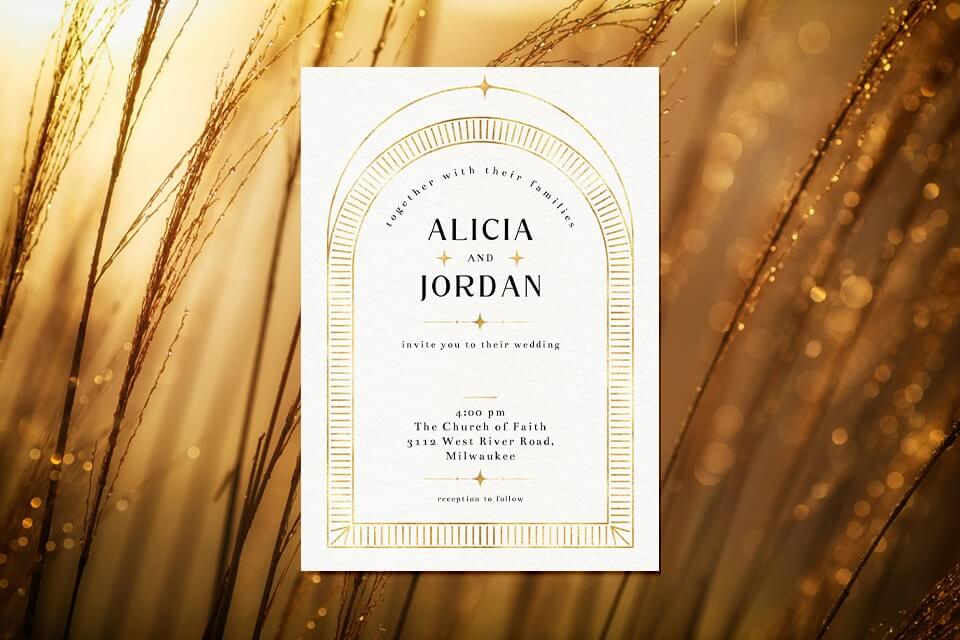 Exquisite golden wedding invitation featuring a white card adorned with a luxurious golden border, set against the backdrop of a picturesque meadow glowing with golden hues during the enchanting sunset