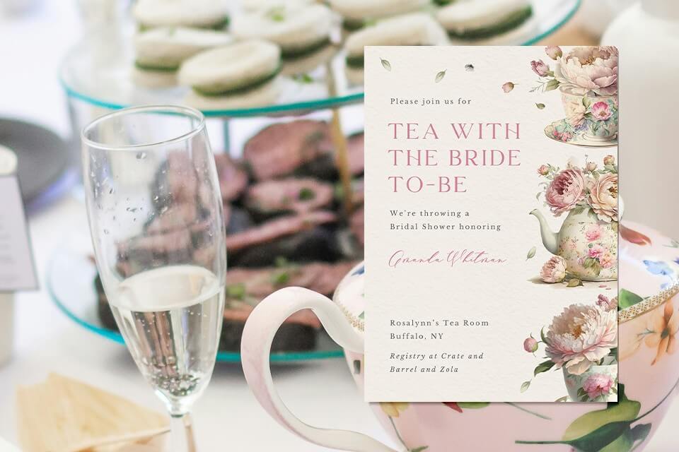 Charming bridal tea party invitation adorned with pastel-colored illustrations of delicate tea cups and a teapot overflowing with vibrant blooms. Against the backdrop of a beautifully set tea party table