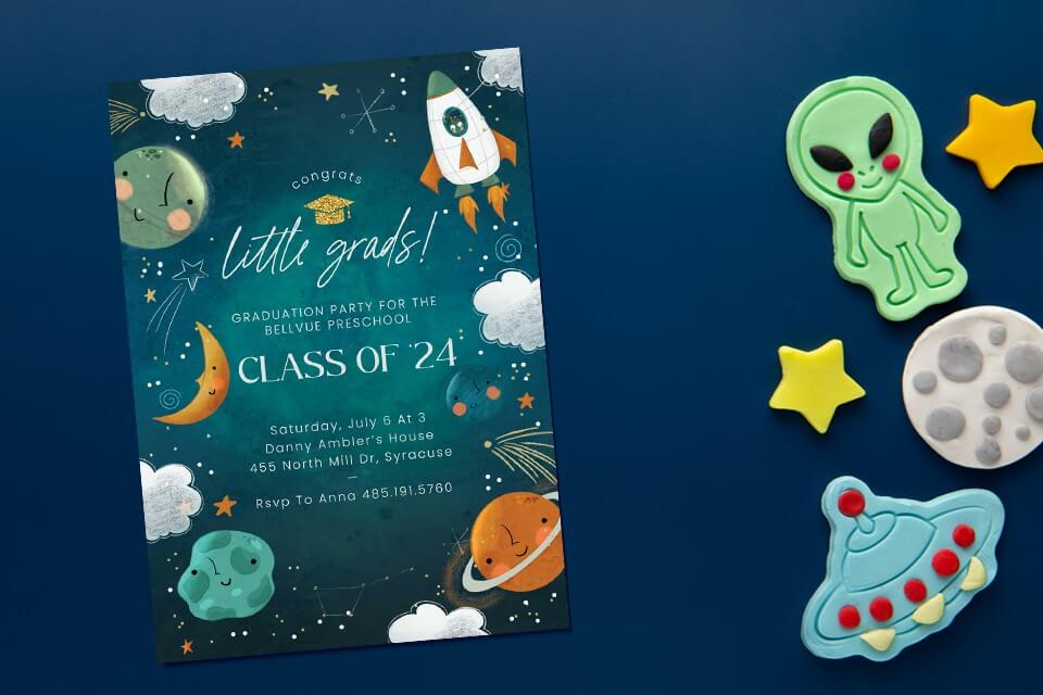 Our little grads, Class of '24, are ready to launch into the next adventure. Our preschool graduation invitation features charming illustrations of space elements like rockets, moons, planets, and constellations. Placed on a dark blue surface adorned with playful alien-themed play dough shapes, stars, and an alien spaceship