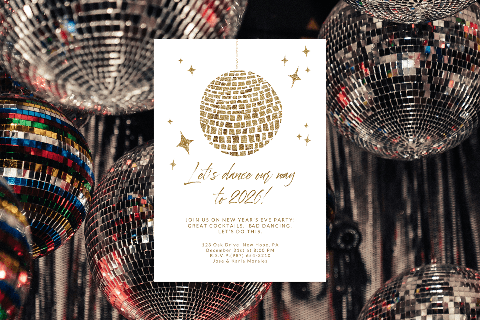 new-discoball-new-years-eve-decor-invite A white New Year’s Eve party invitation with a gold glitter disco ball illustration hanging at the top, surrounded by small gold star accents. The text reads ‘Let’s dance our way to 2026!’ with event details below. The invite is placed against a background filled with colorful, reflective disco balls.