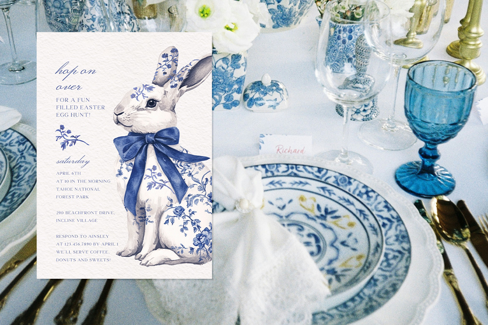 ornamental-bunny-easter-invite Elegant Easter invitation featuring a blue floral bunny illustration placed over a refined table setting with patterned china, glassware, and gold cutlery.