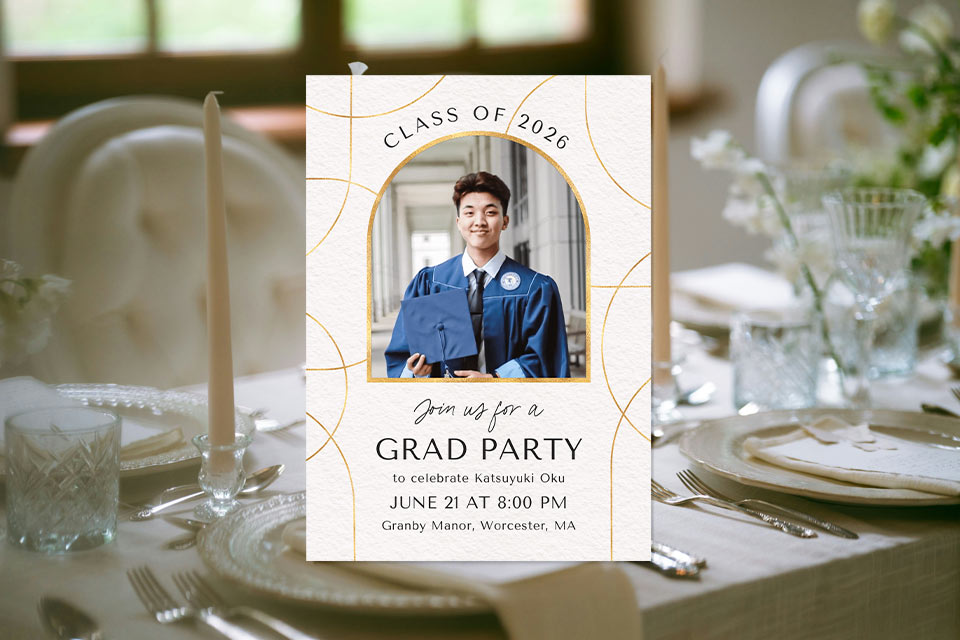 graduation-invite-dinner-party Elegant graduation party invitation with a photo of a graduate in cap and gown, set over a softly styled dinner table background with candles and glassware.